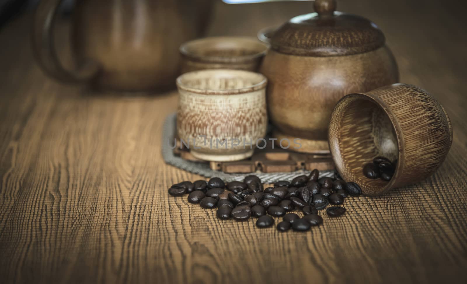 Vintage photo of coffee beans and Coffee cups set on wooden background.Vintage style.