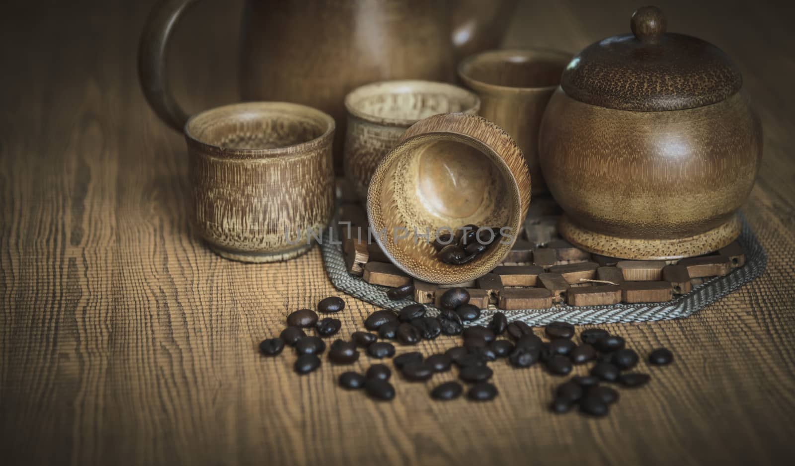 Vintage photo of coffee beans and Coffee cups set on wooden background.Vintage style.