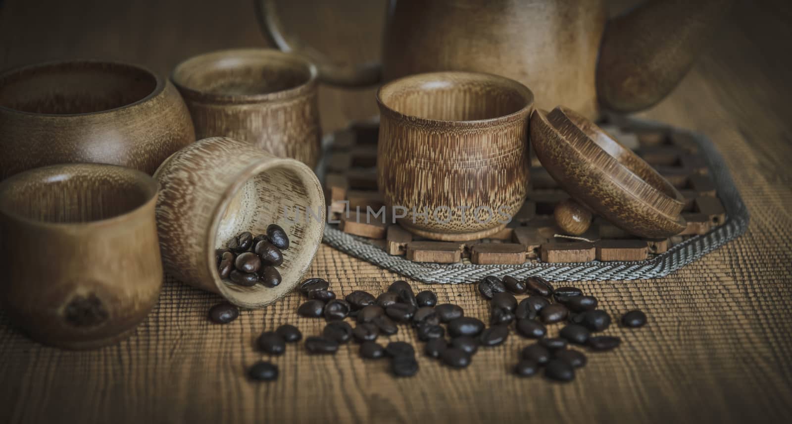 Vintage photo of coffee beans and Coffee cups set on wooden background.Vintage style.