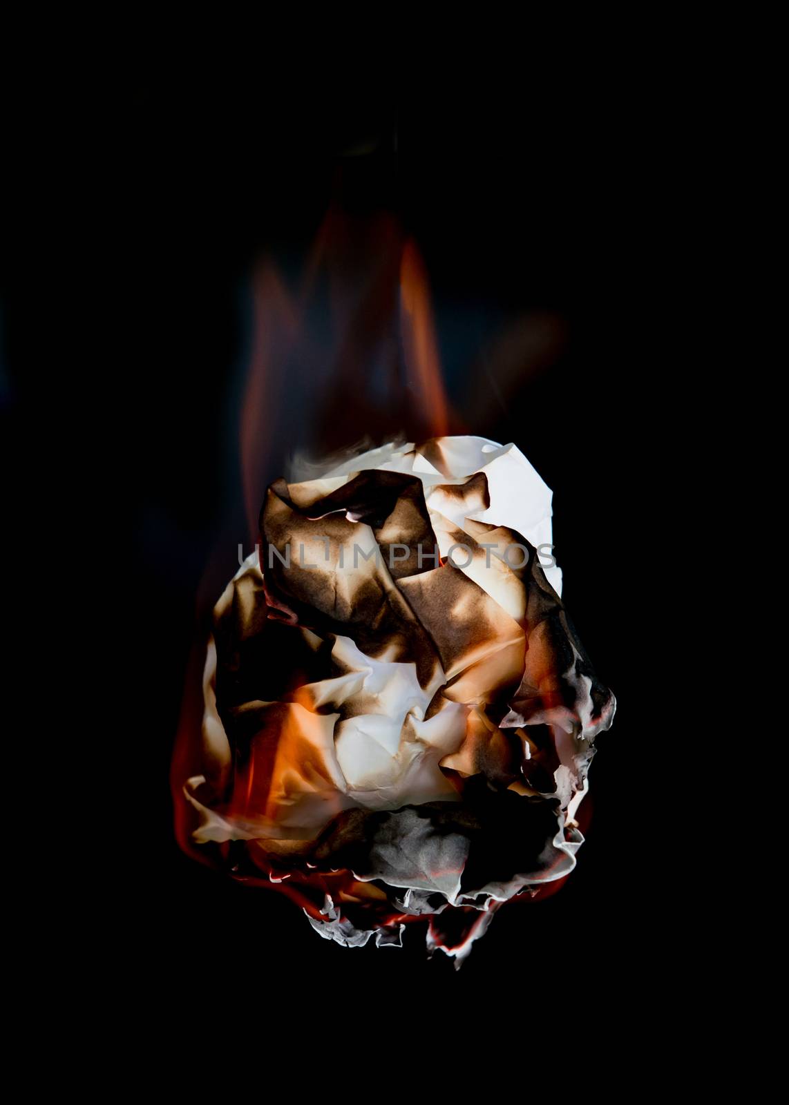 white crumpled  paper burning on black background