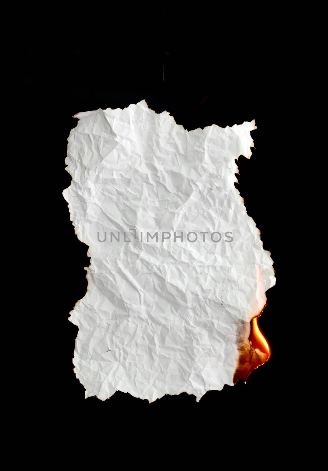 white crumpled  paper burning on black background