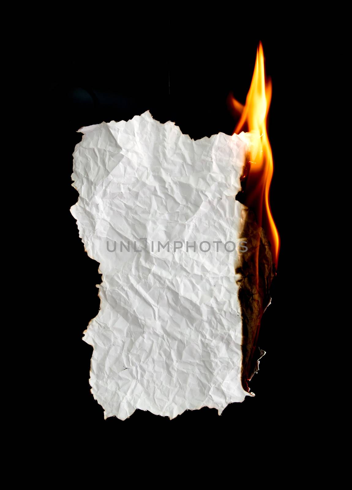 white crumpled  paper burning on black background