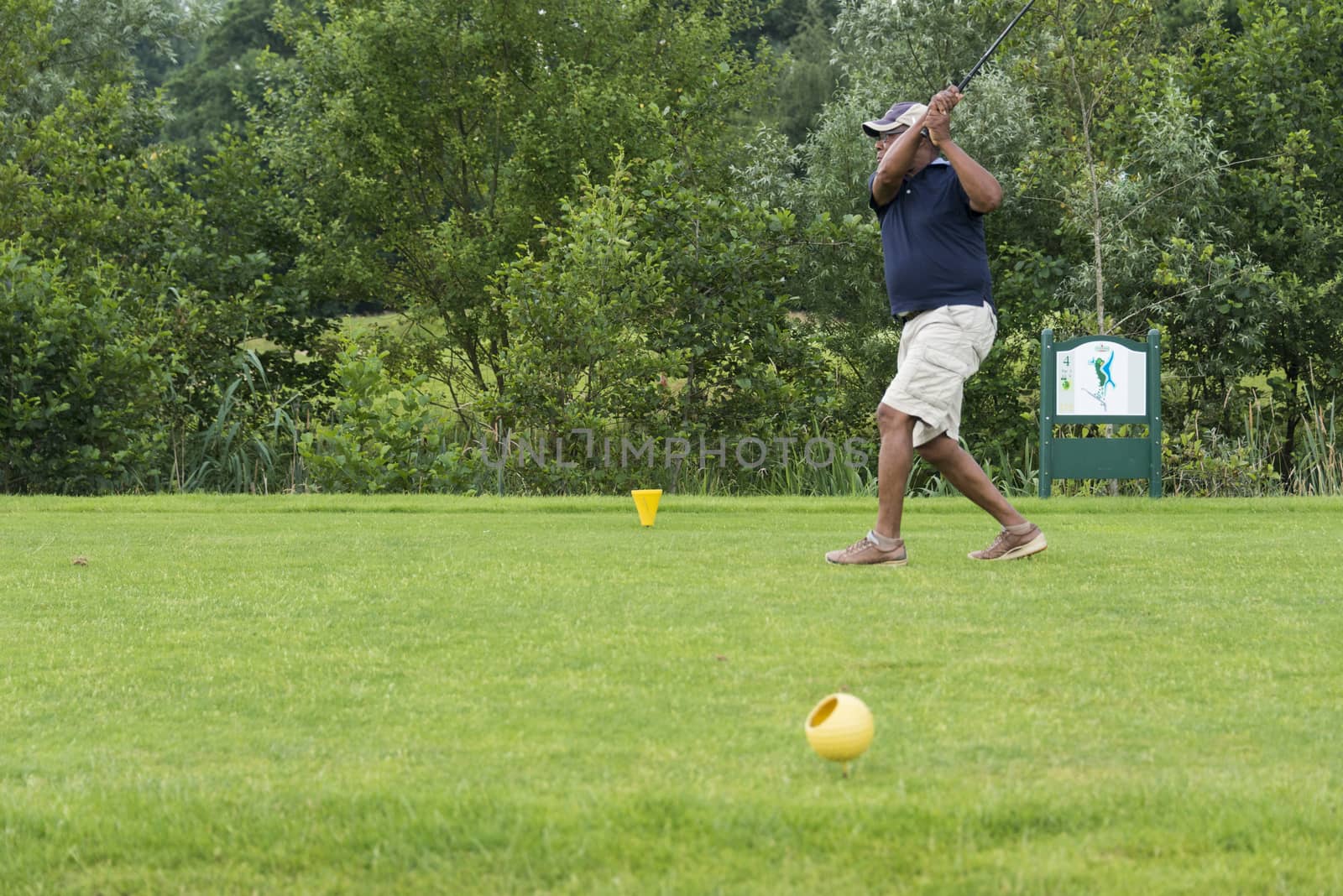 man playing golf on golftrack by compuinfoto