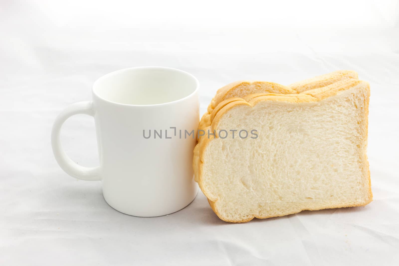 Empty coffee cup or coffee mug and sliced bread isolated on white background.