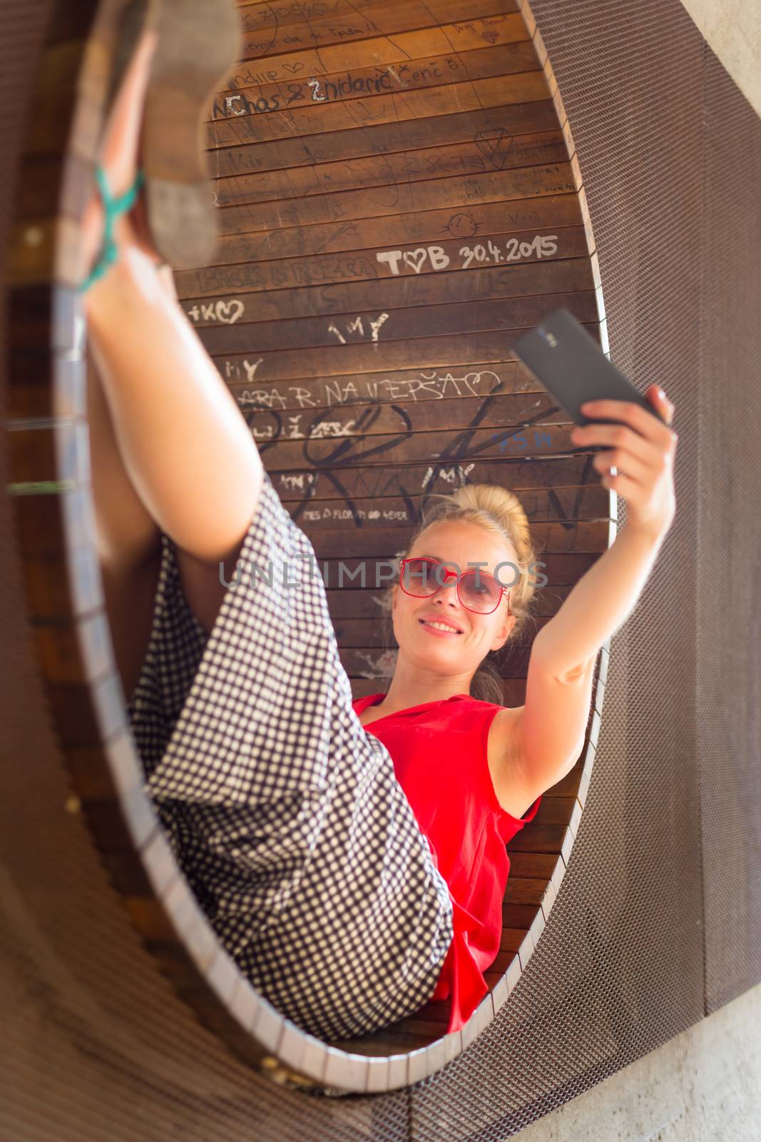 Young cheerful lady taking selfie. by kasto