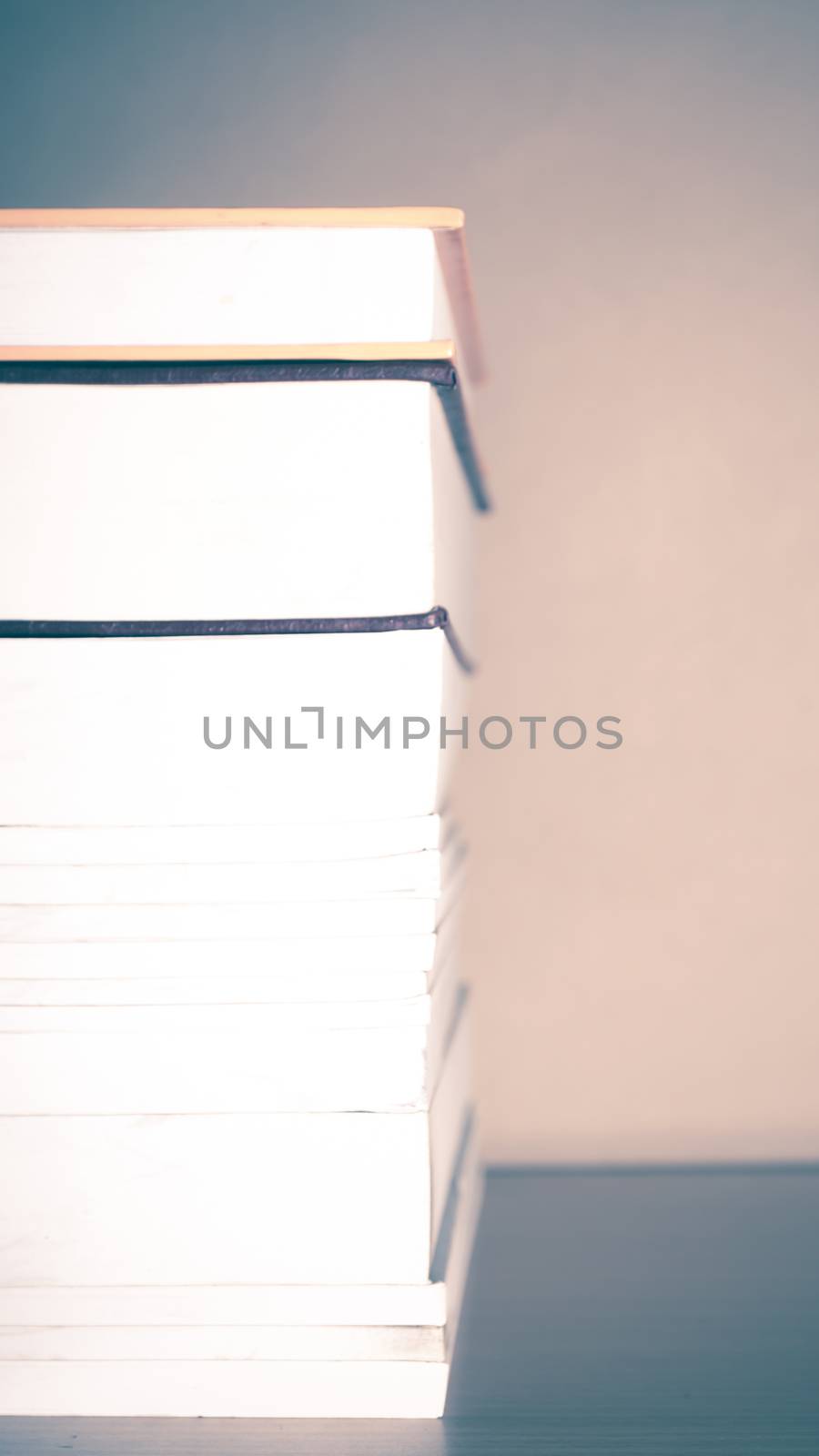 stack of book on wood table background vintage style