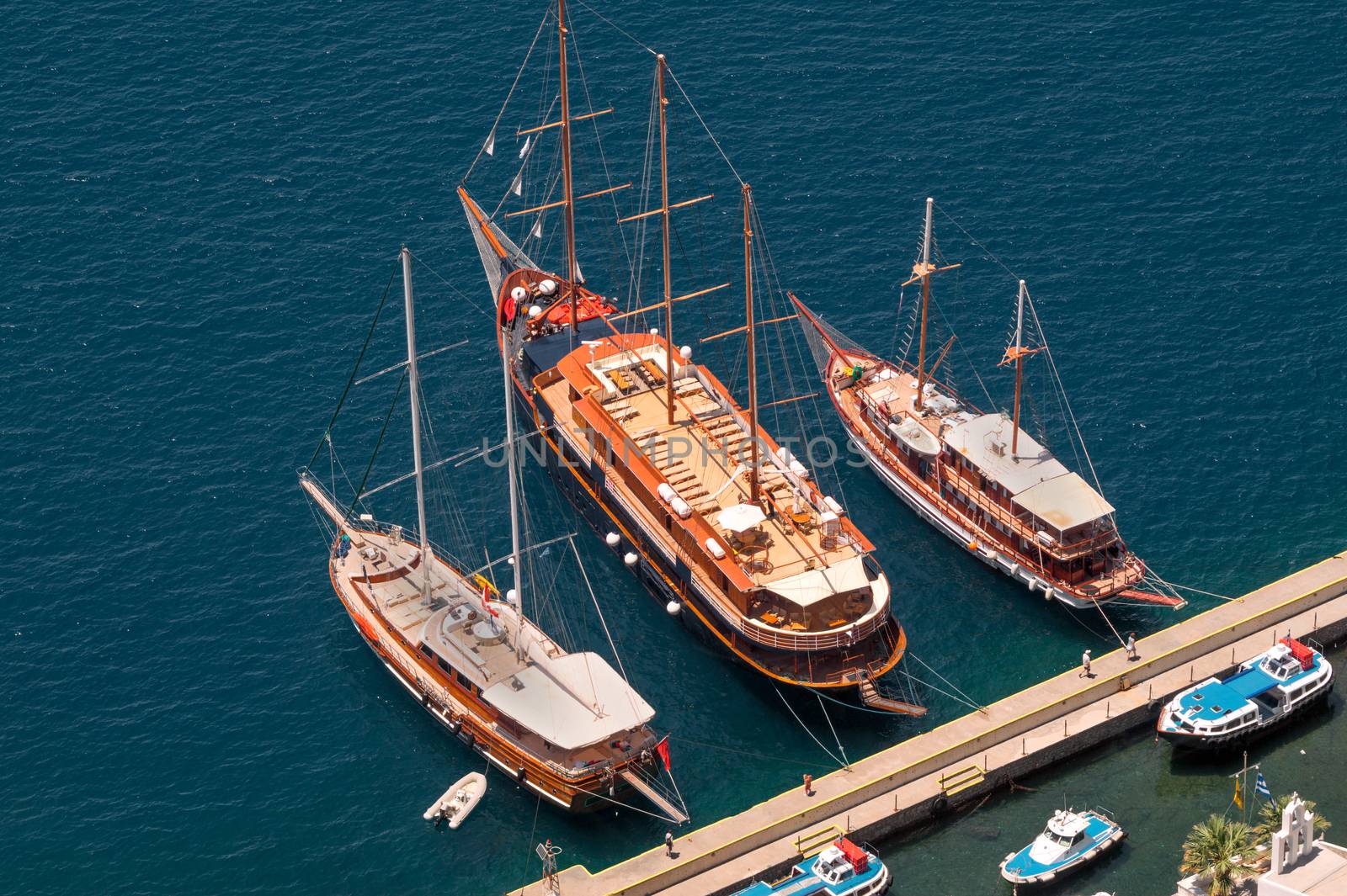 Three vintage wooden ships on Santorini island, Greece