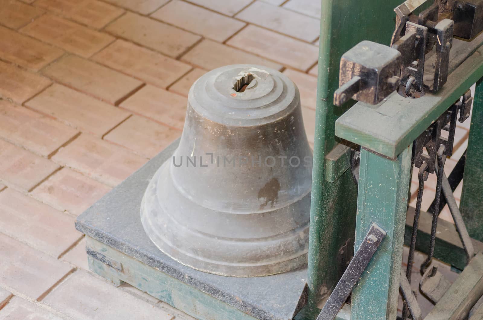 Bell is weighed on an old antique decimal scale.
