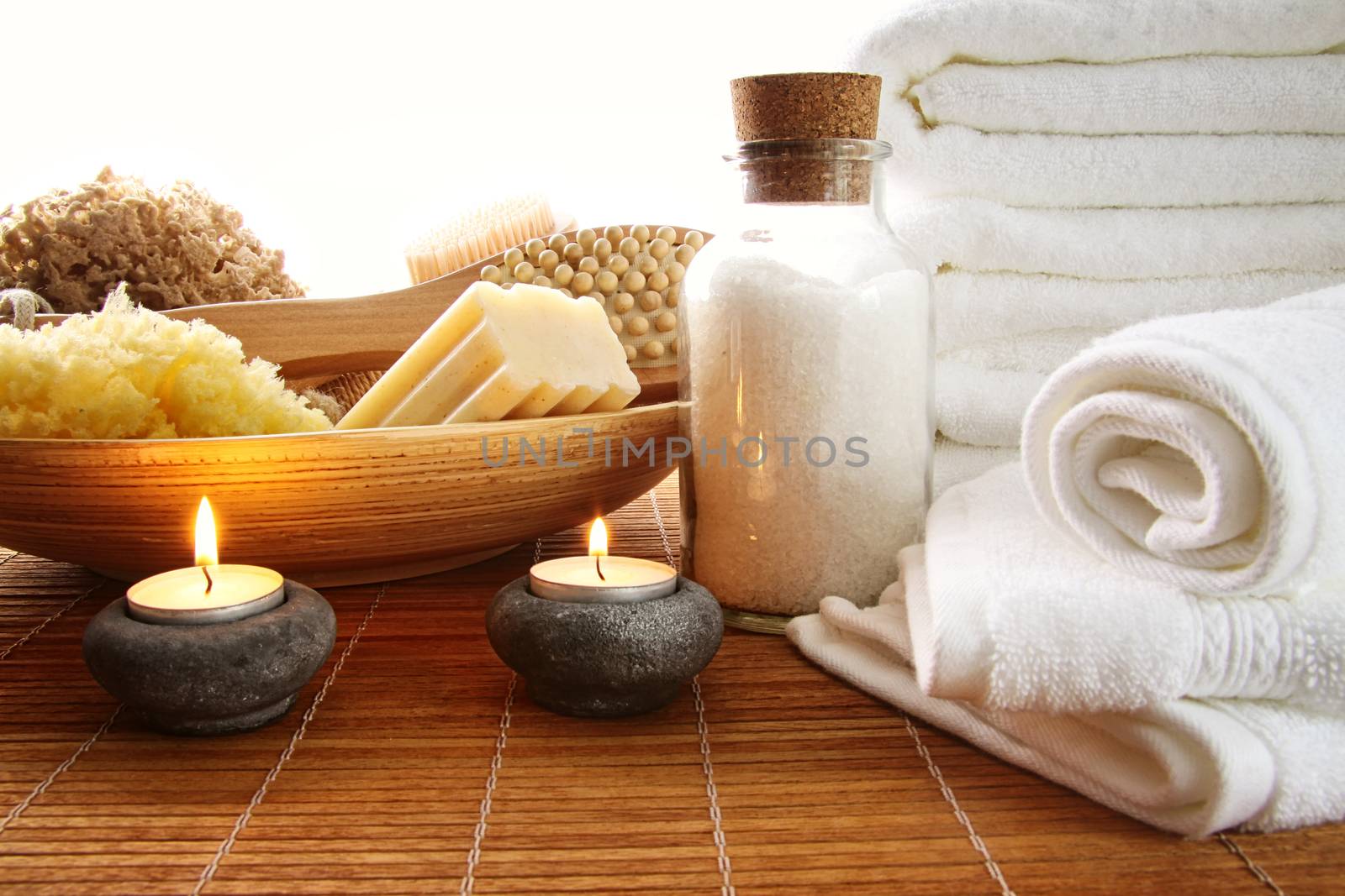 Spa setting with candles, sea salt and towels