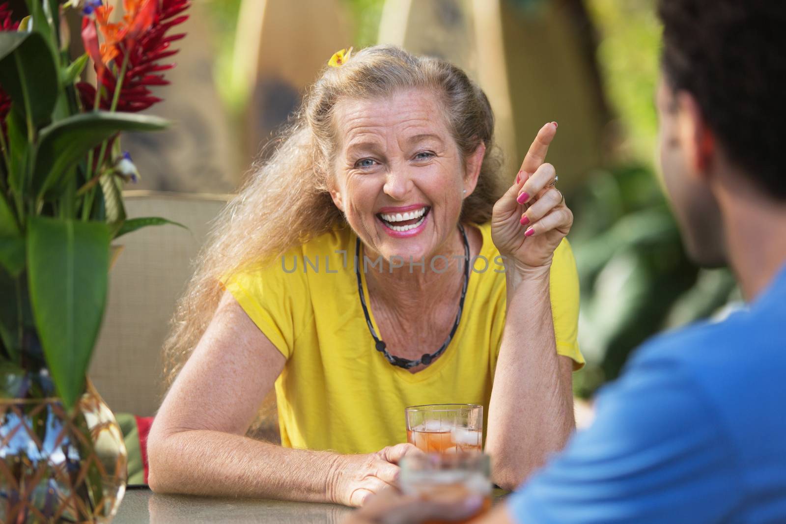 Adult woman smiling and pointing finger at friend