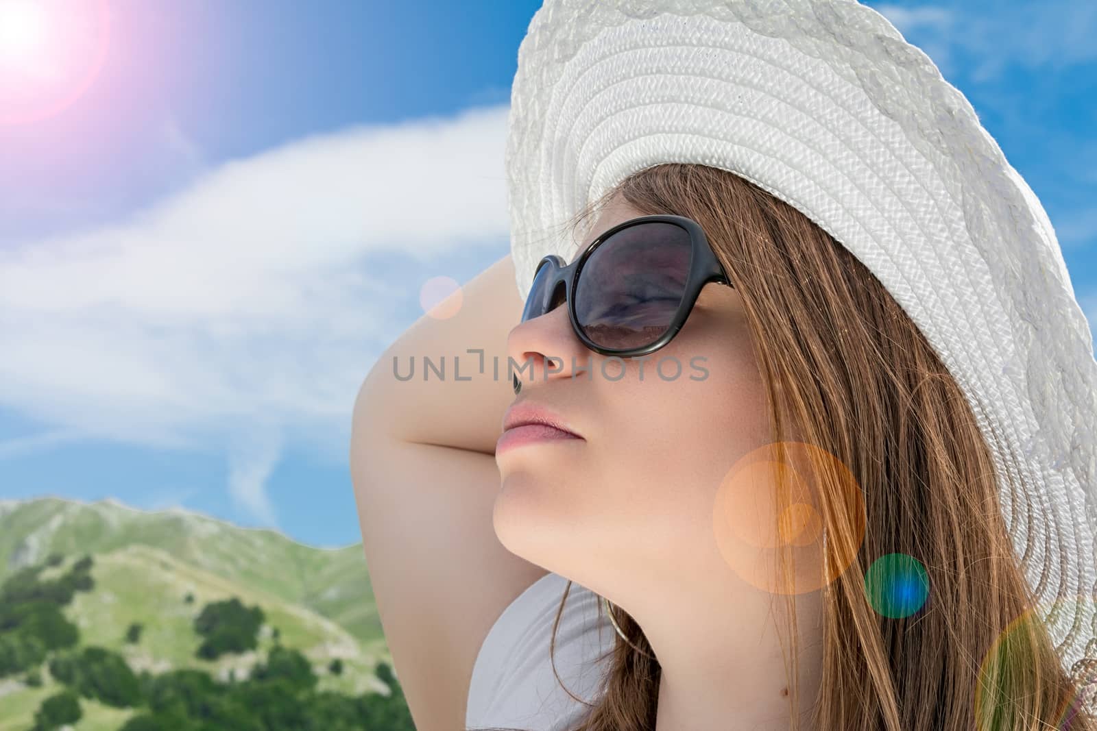 blonde girl with sunglasses in the mountain