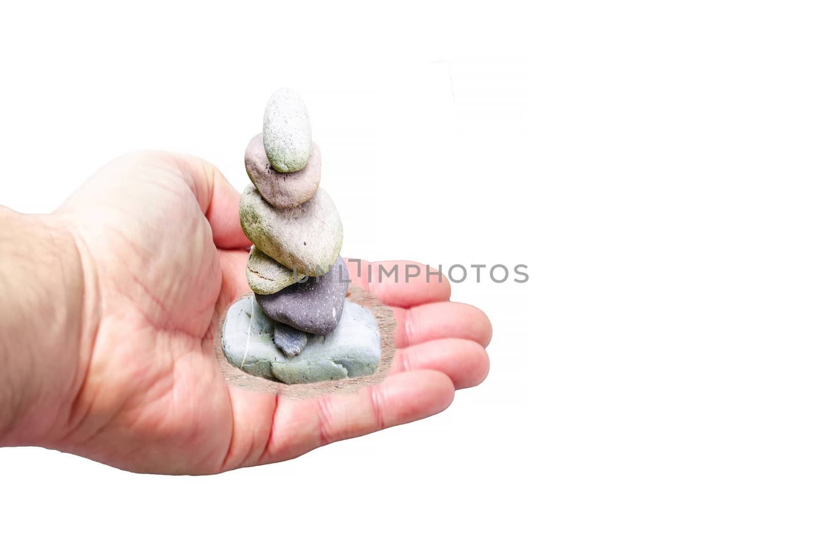 Gravel pile, small stone tower in hand. Symbol of balance and harmony.