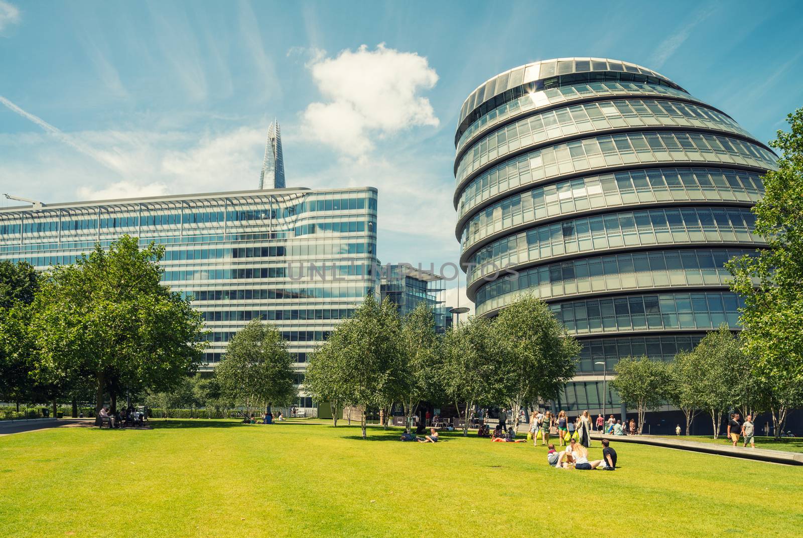 Tourists walking along Potters Fields Park along Thames riverside, London - UK