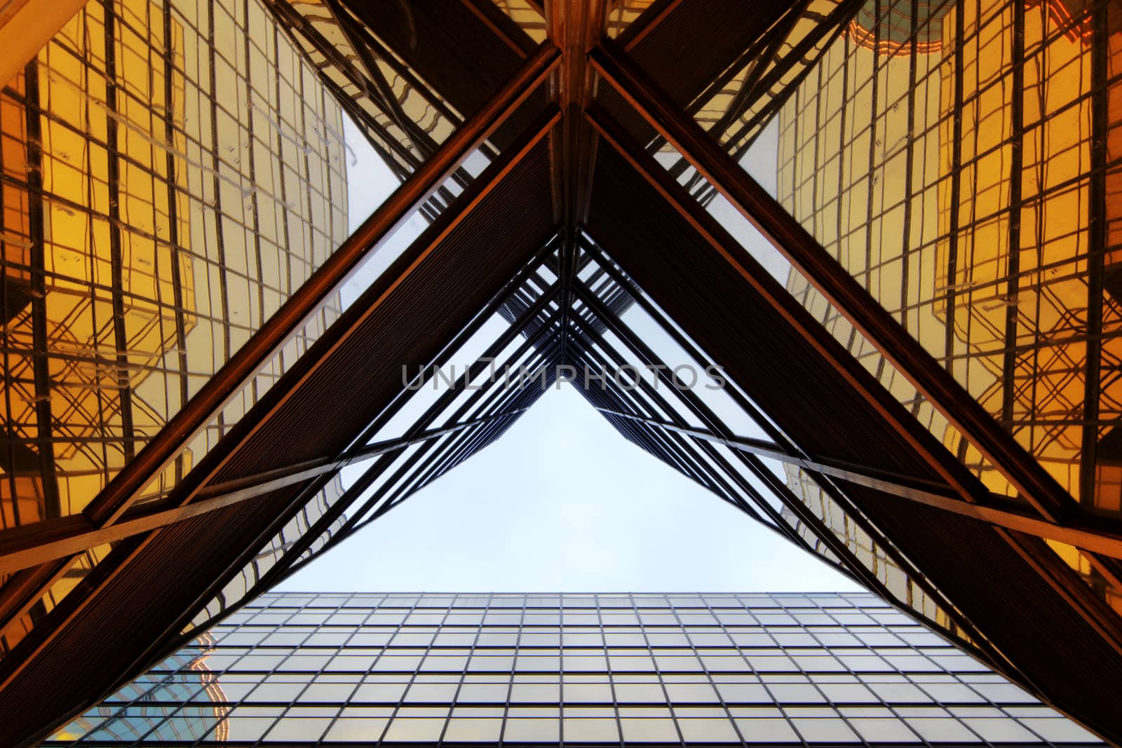 Panoramic and perspective wide angle view to steel light blue background of glass high rise building skyscraper commercial modern city of future. Business concept of successful industrial architecture