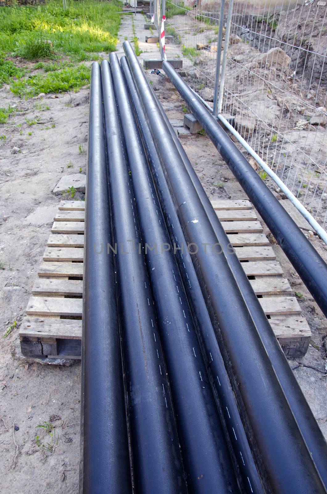 new industrial plastic heating pipes tube stack near trench in city