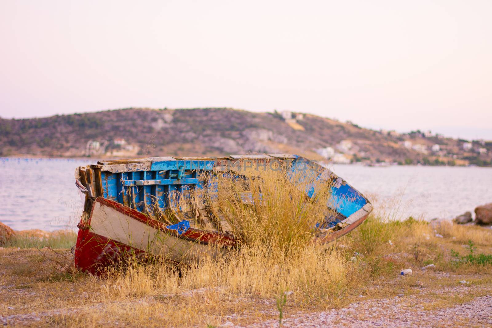View of an old rusty boat out of the water.