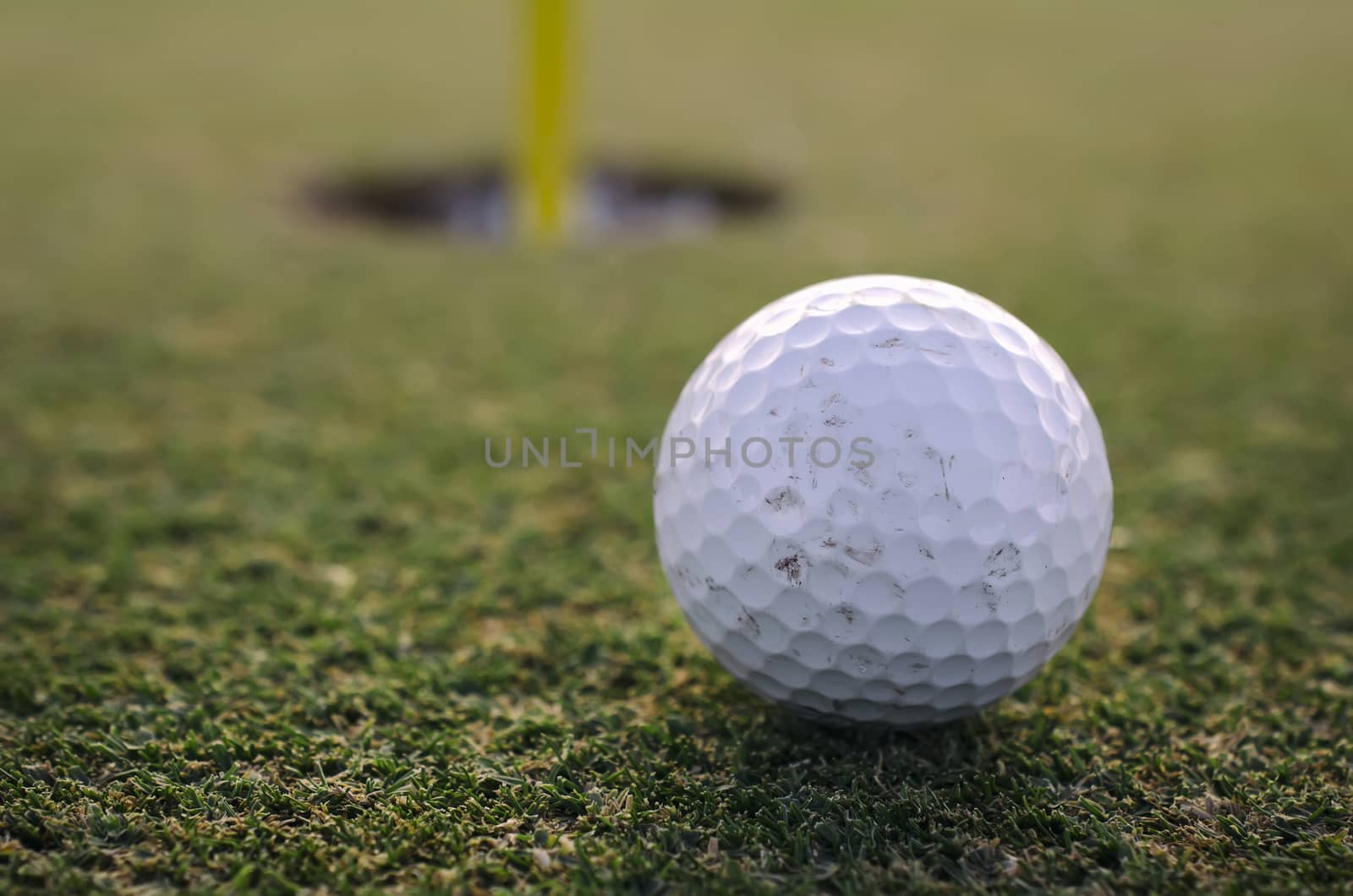 Golf Ball close to hole