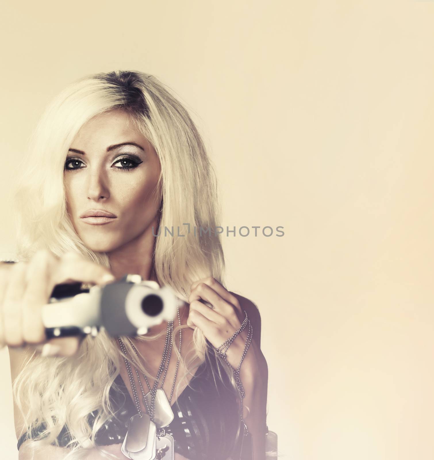 Beautiful blond woman holding gun by Paulmatthewphoto