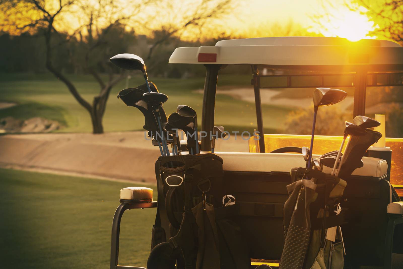 Golf cart - beautiful sunset overlooking gold course by Paulmatthewphoto