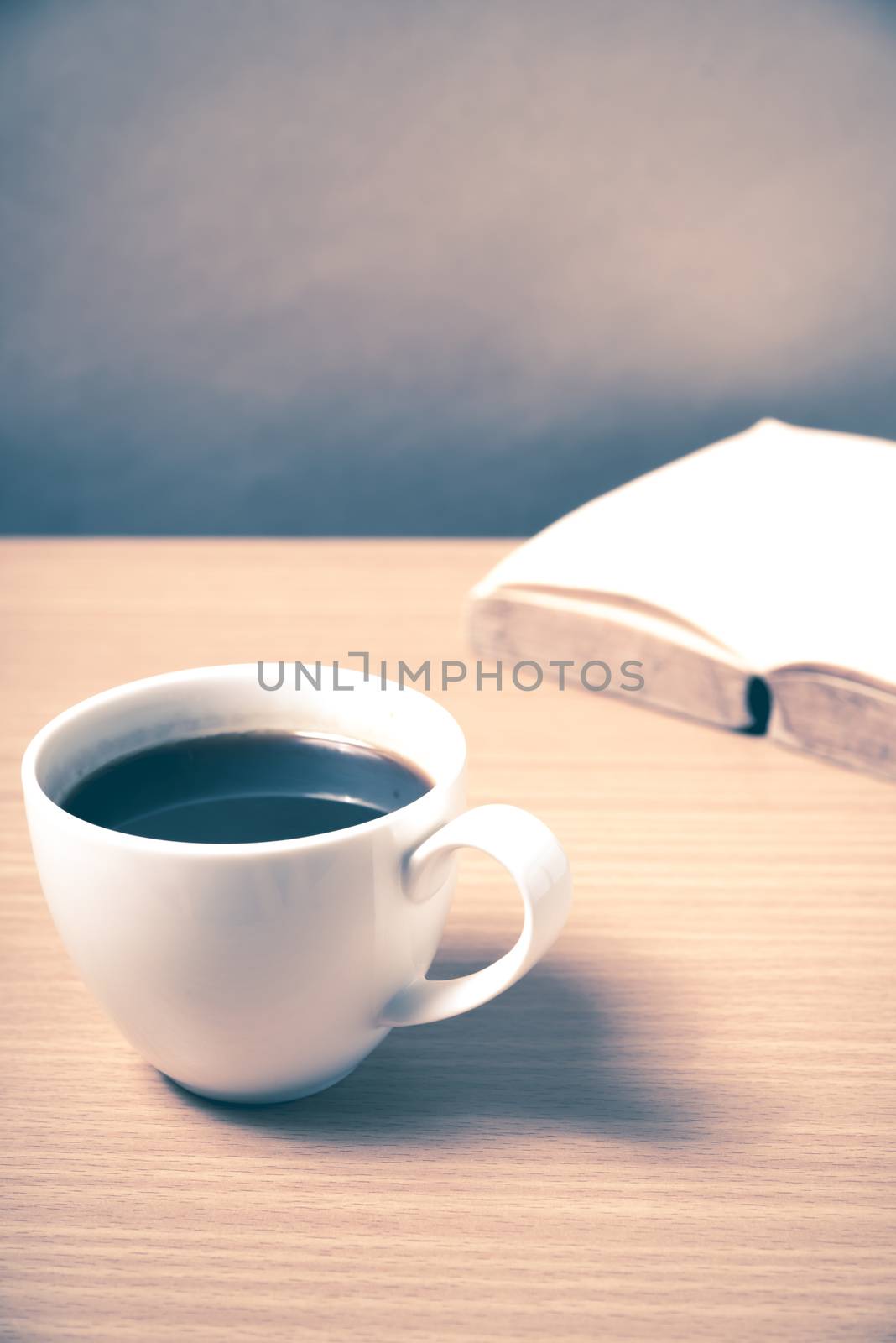 open book with coffee on wood background vintage style