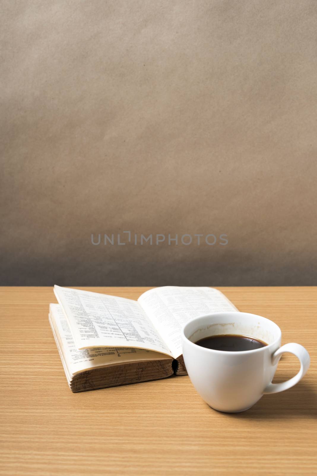 open book with coffee on wood background