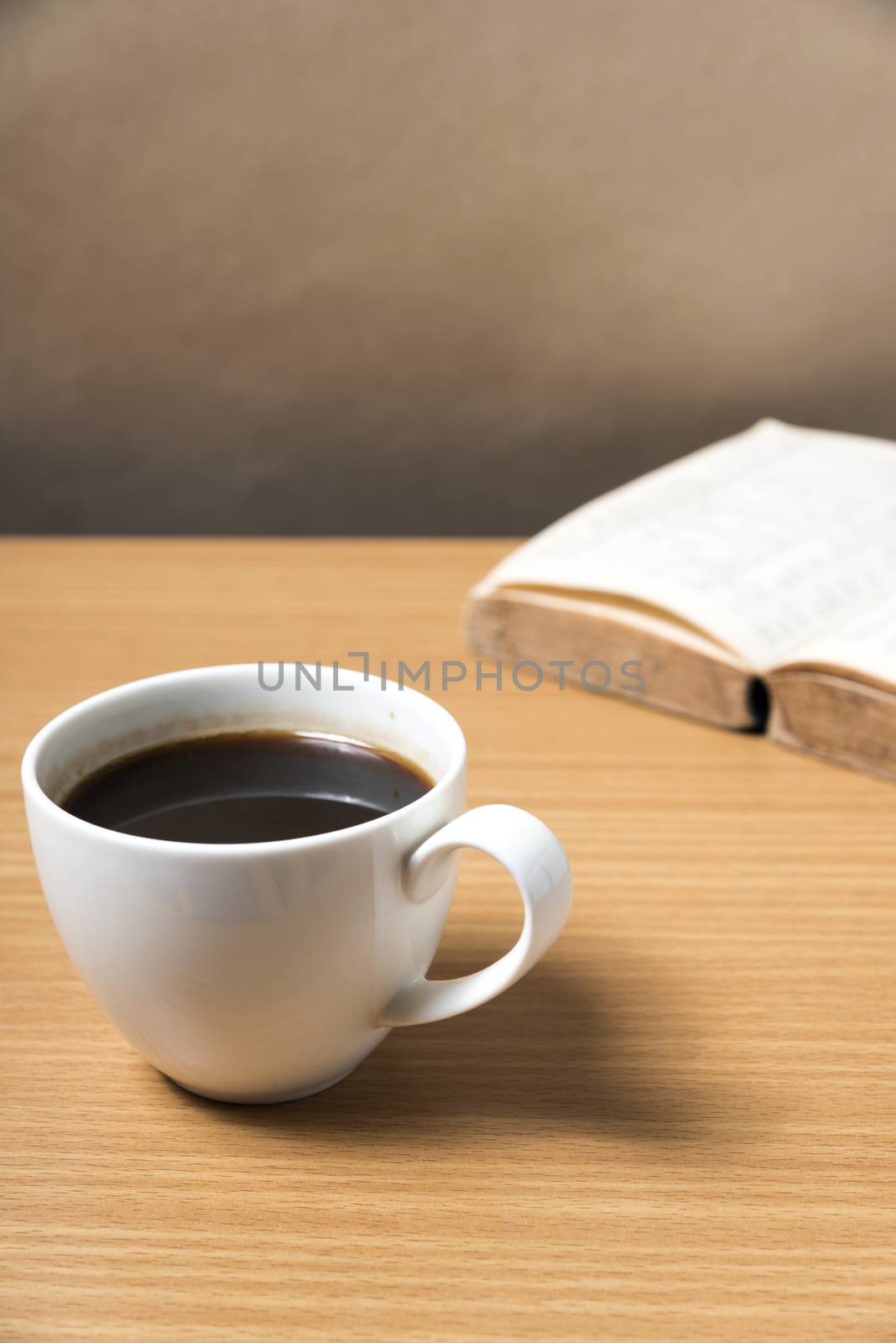 open book with coffee on wood background