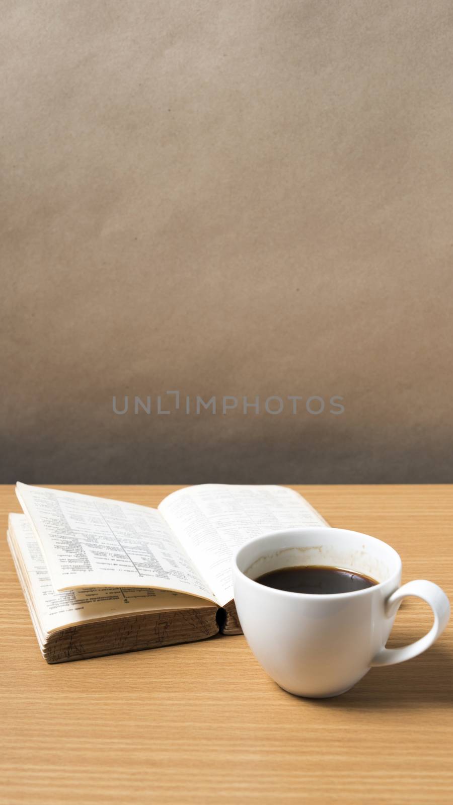 open book with coffee on wood background