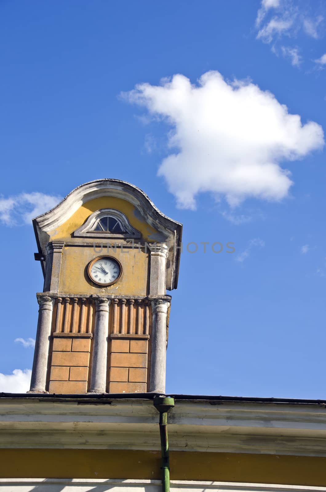 tower with ancient clock on old manor roof and sky with cloud