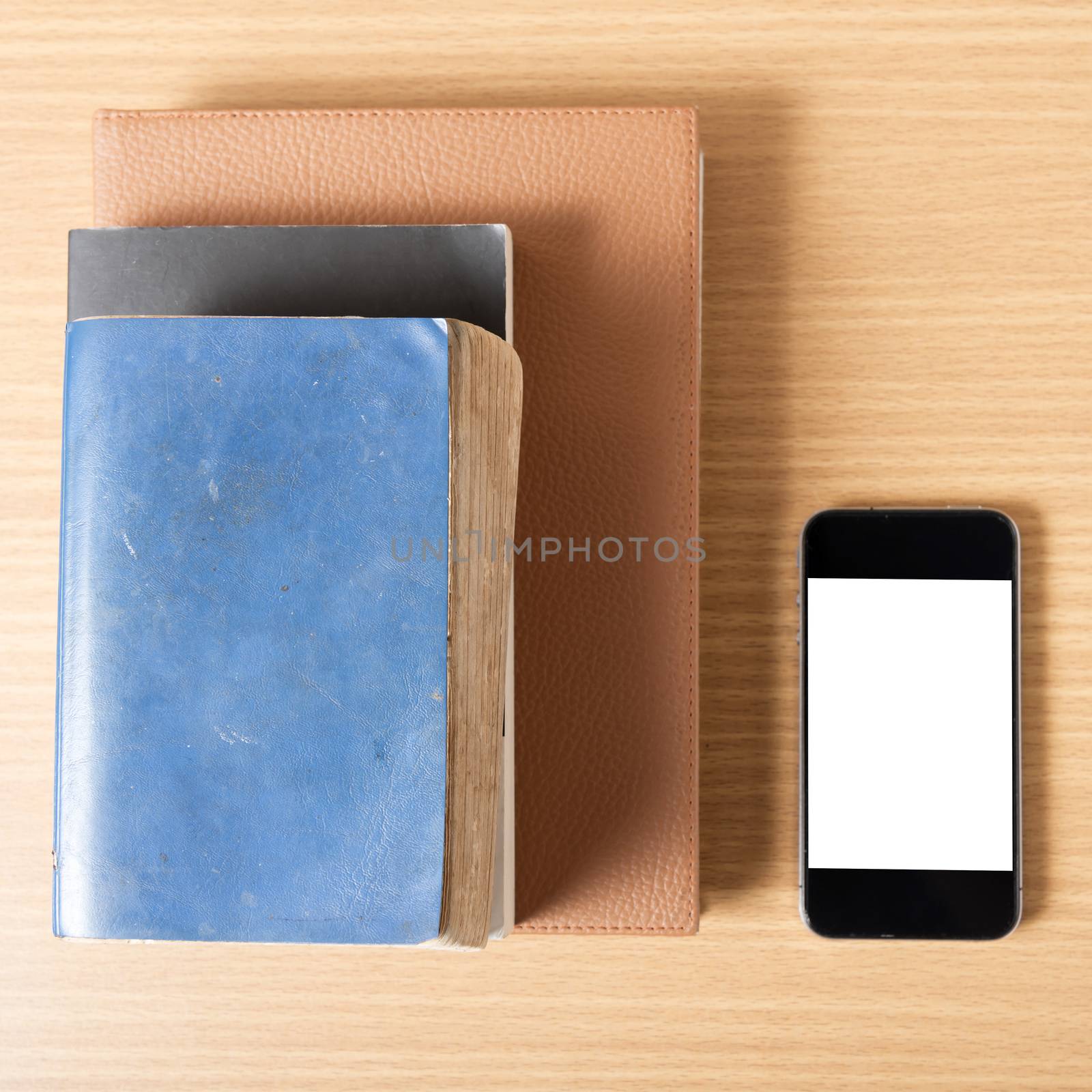 stack of book and smart phone on wood background