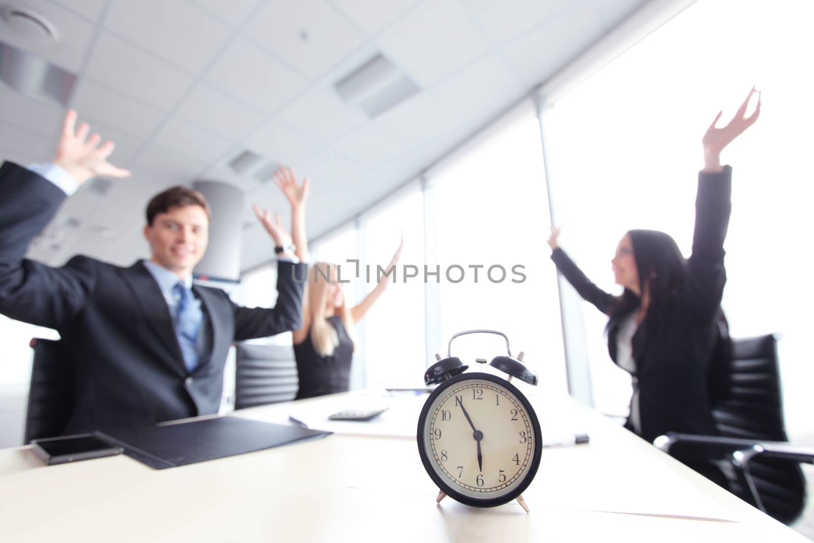 Businessmen in office and alarm clock, deadline concept
