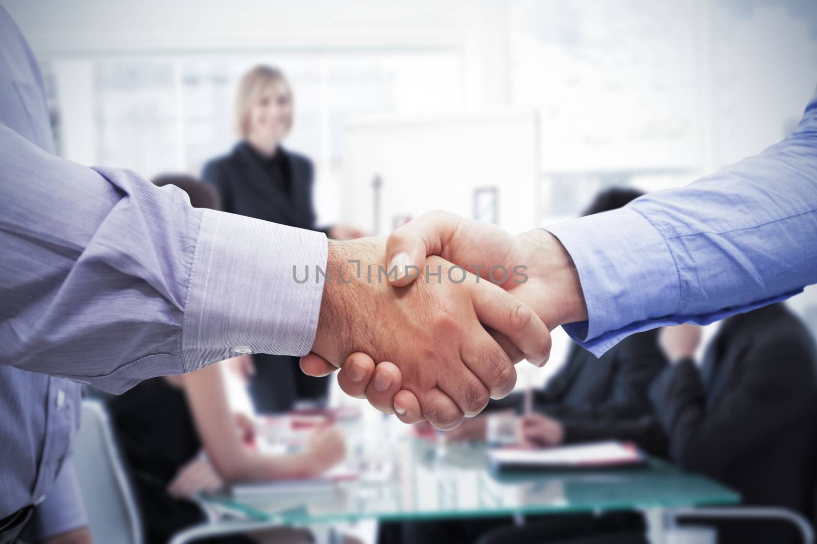 Men shaking hands against businesswoman reporting to sales in a seminar