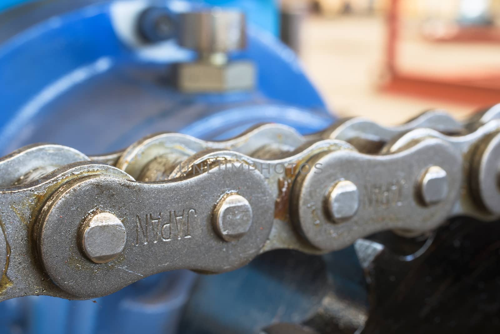 Extreme close-up of chain. Very shallow depth of field with only a part of the nearest chain link in focus.