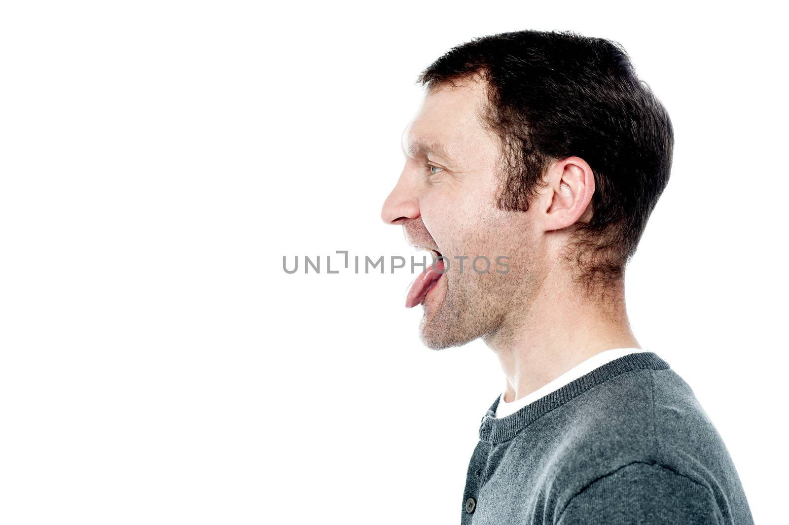 Man showing his tongue out by stockyimages