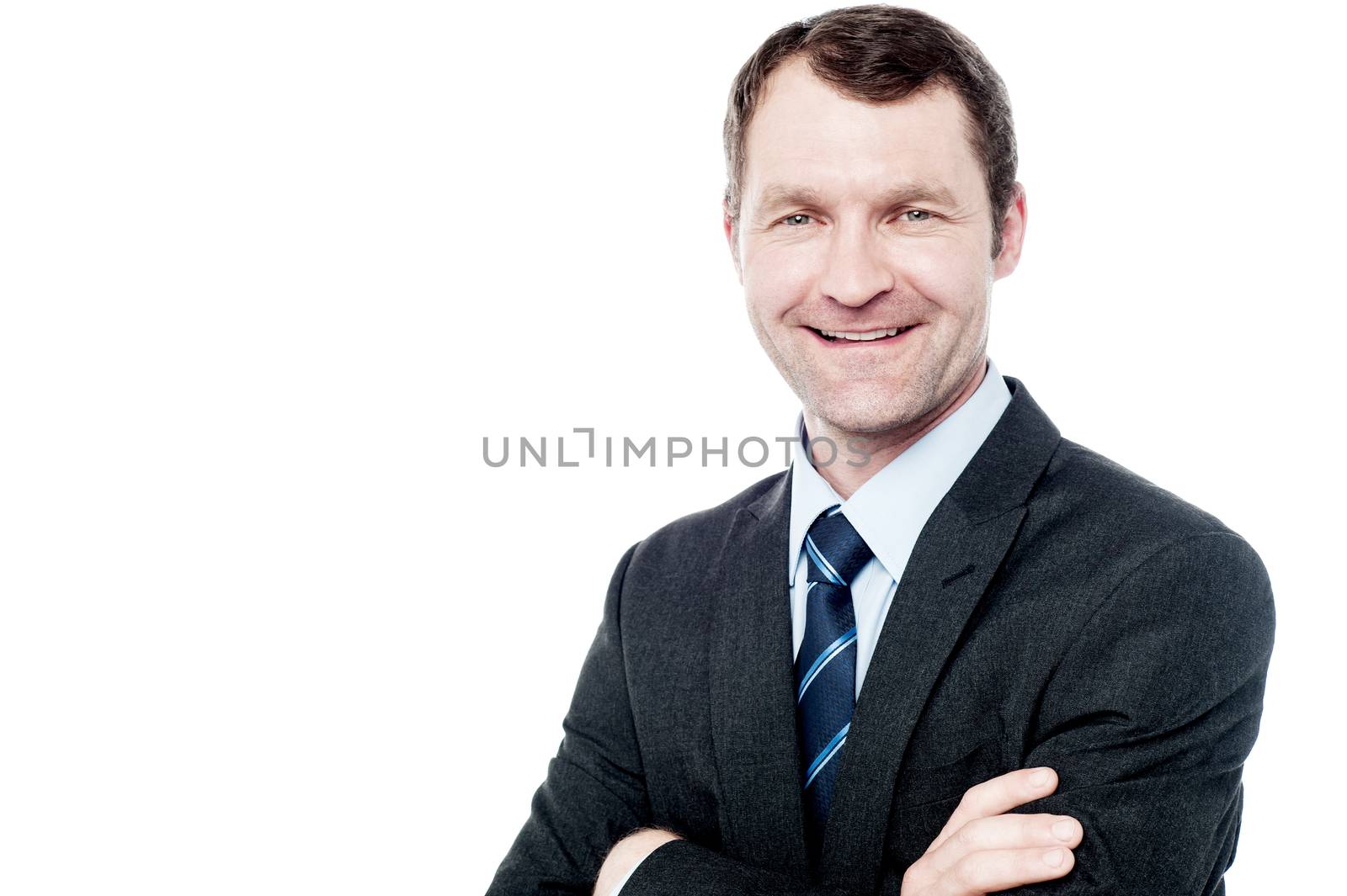 Successful businessman posing with folded arms