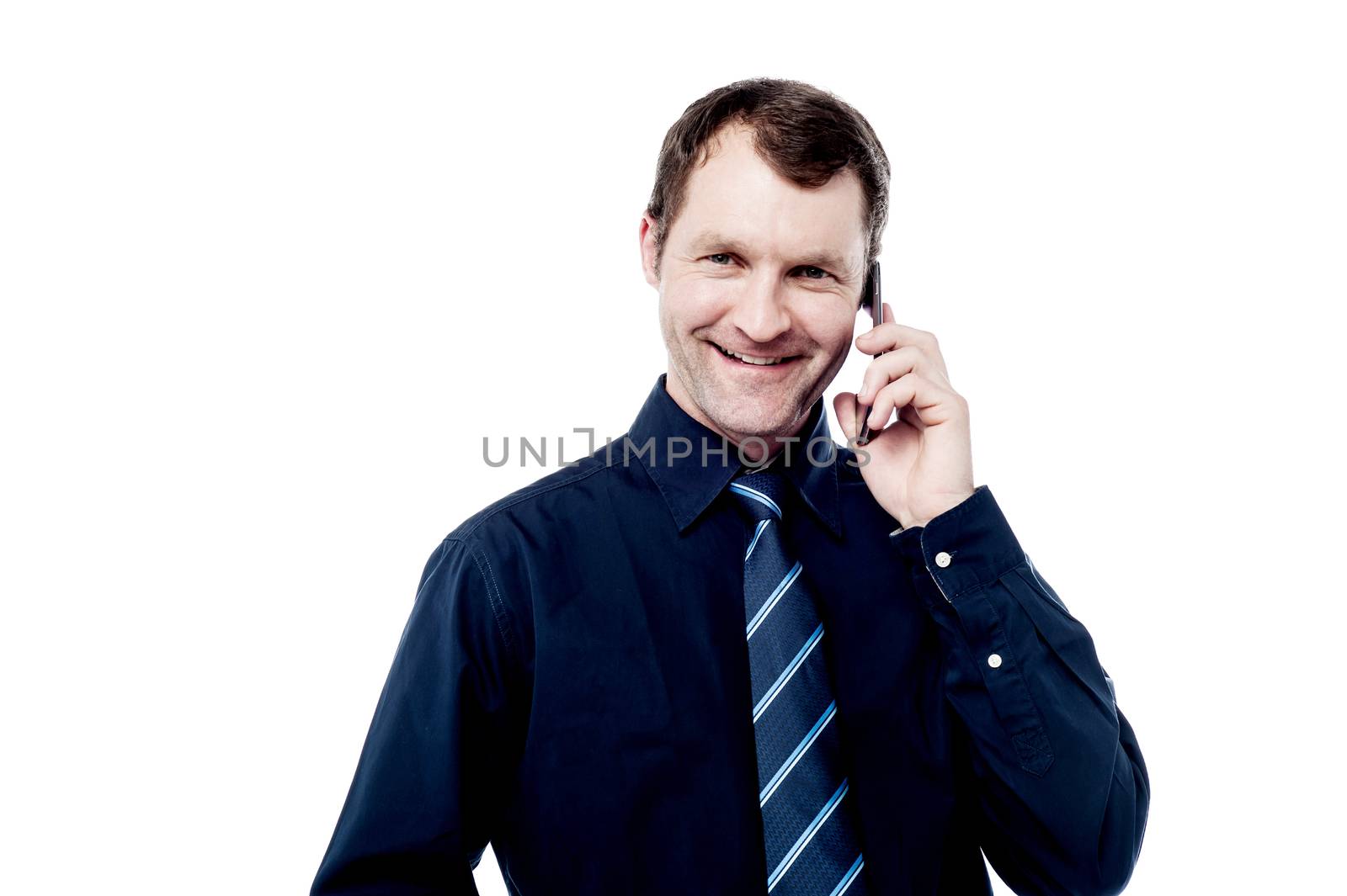 Smiling corporate male talking on his mobile