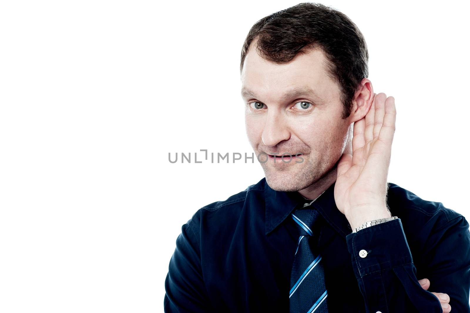 Relaxed businessman with hand behind ear