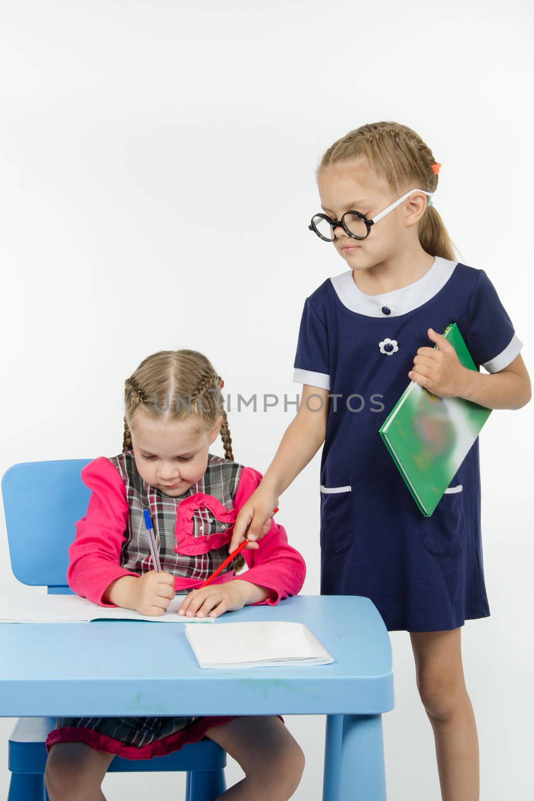 Two girls play school teacher and student