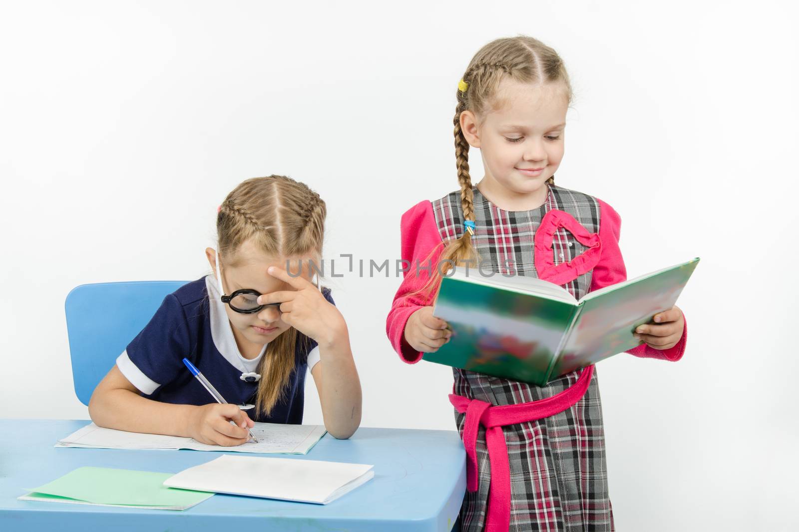 Two girls play school teacher and student