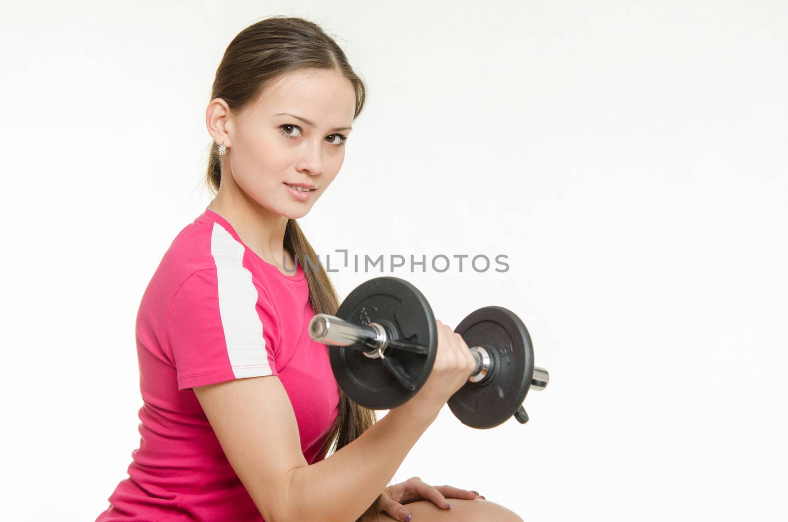 Young beautiful girl athlete spends Europeans physical exercise