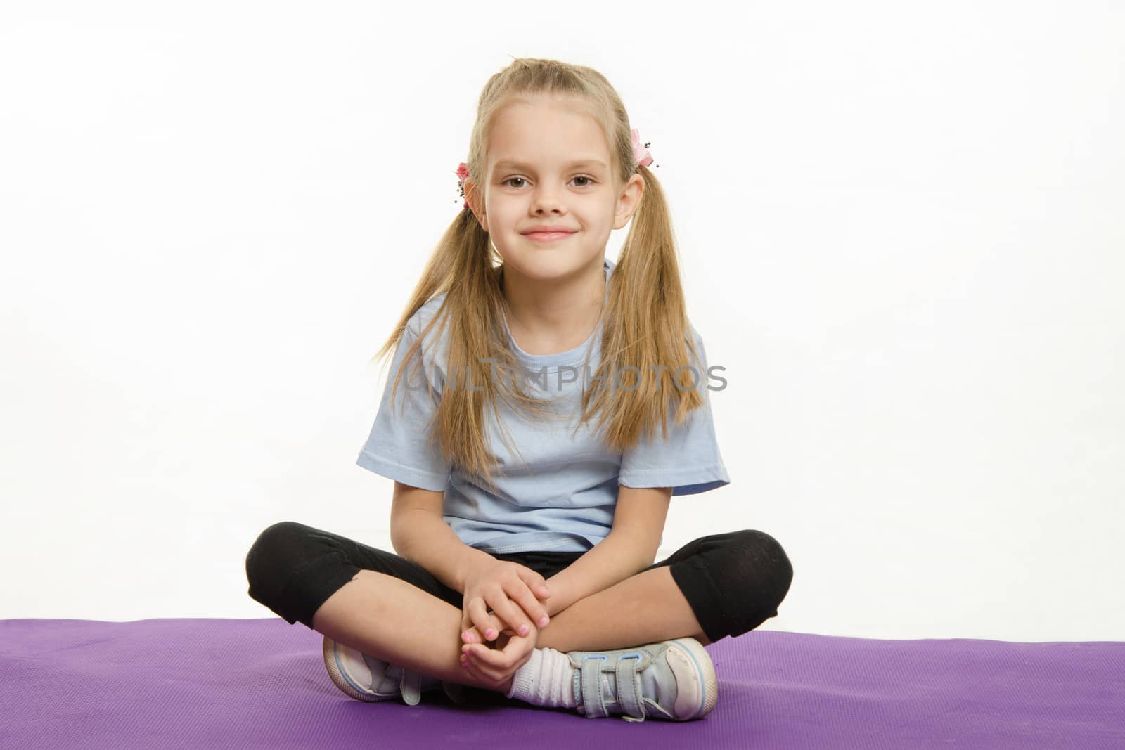 Six year old girl sitting on the Europeans sports rug