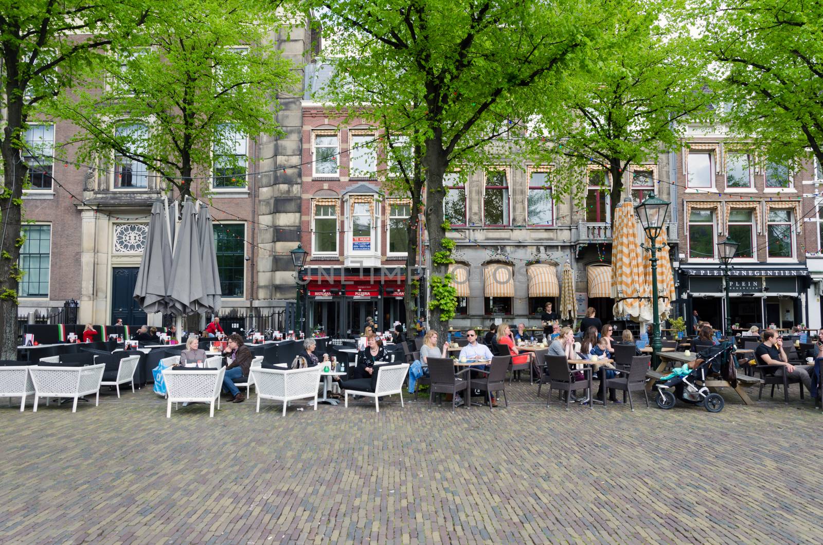 The Hague, Netherlands - May 8, 2015: Dutch People at Cafeteria in Het Plein in The Hague's city centre, Netherlands. on May 8, 2015.