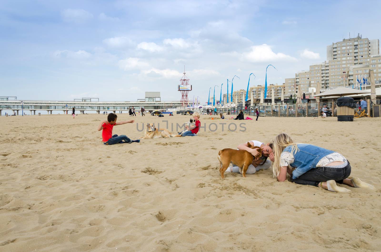 The Hague, Netherlands - May 8, 2015: Children playing at the beach, Scheveningen district in The Hague by siraanamwong