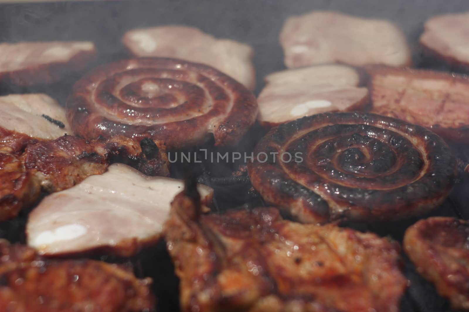 Barbecuing meat on charcoal fire closeup image. by eicvl5