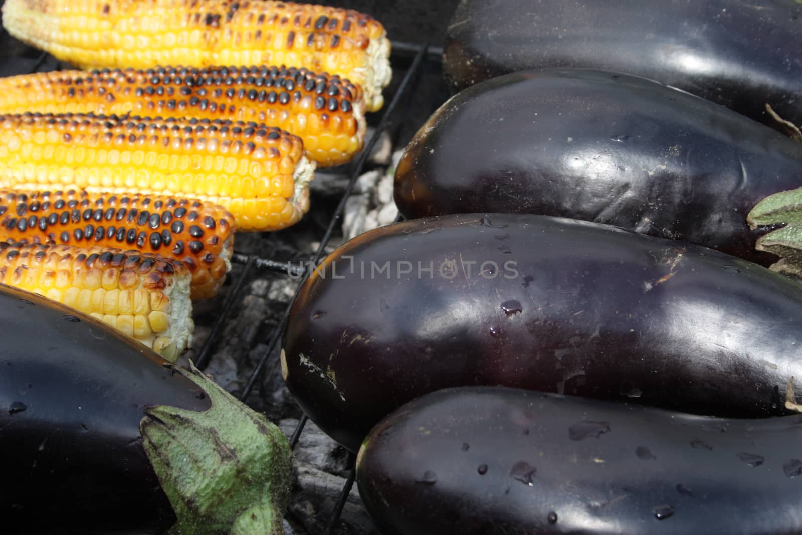 Barbecuing vegetables on charcoal fire closeup image.
