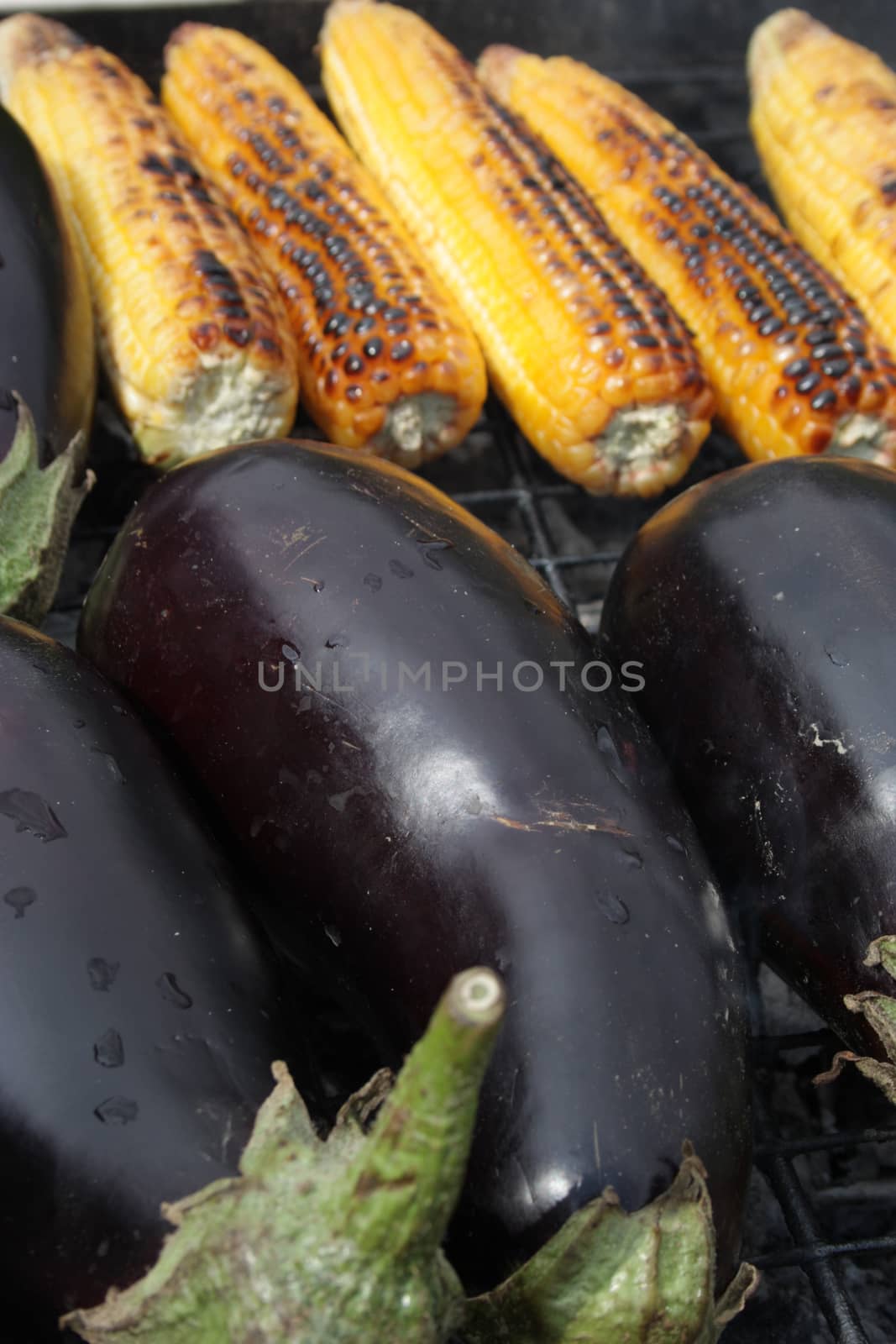 Barbecuing vegetables on charcoal fire closeup image.
