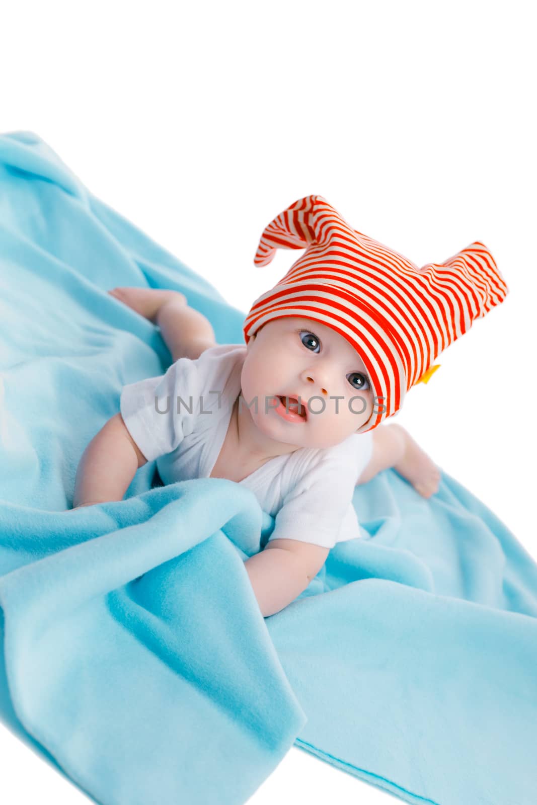 baby in a striped hat on a blue blanket