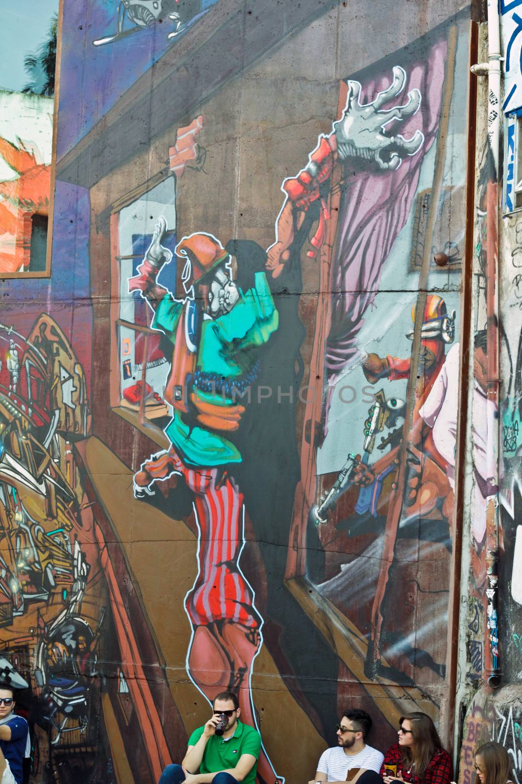 Sao Paulo, Brazil July 18, 2015: Unidentified group of people in front of graffiti of unidentified artist on the wall of the Batman alley in Sao Paulo Brazil.