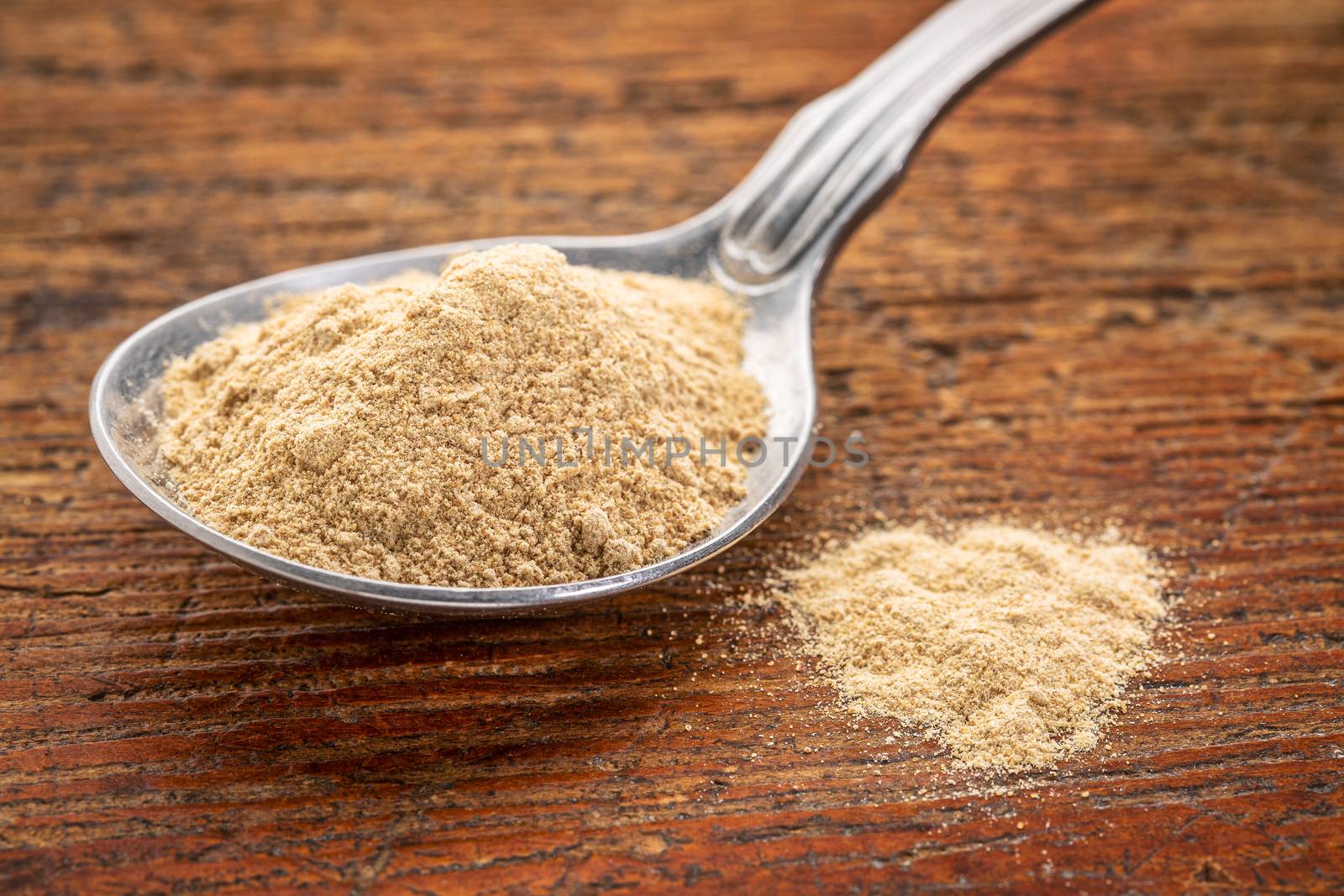 maca root powder on tablespoon by PixelsAway