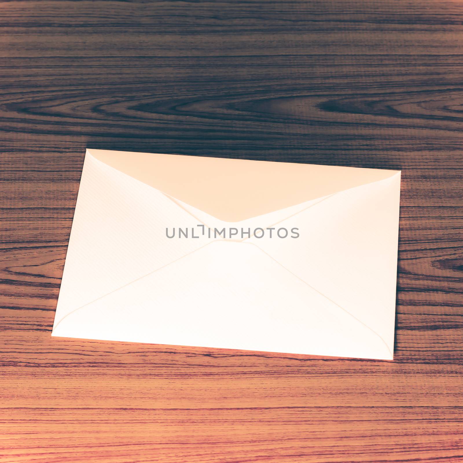 soft pink envelope on wooden background vintage style
