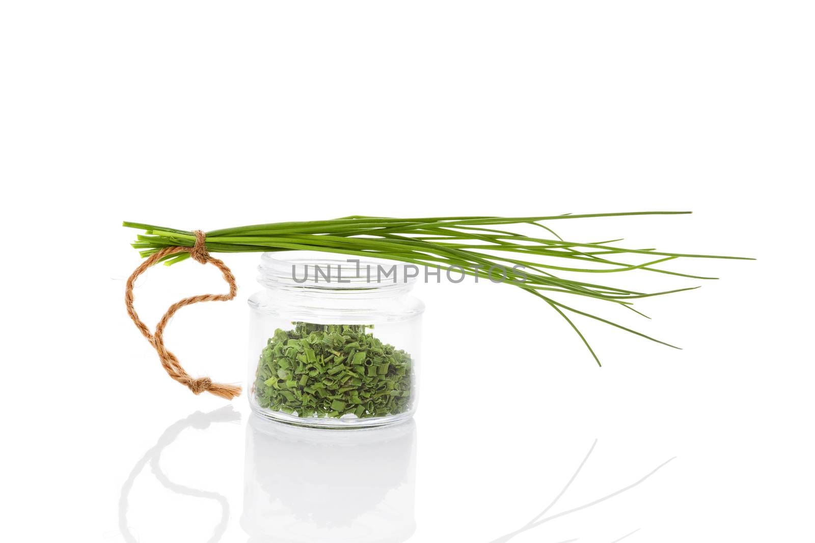 Fresh chives and dry chive spice in glass jar isolated on white background. Culinary healthy aromatic herbs. Fines herbes, culinary arts.